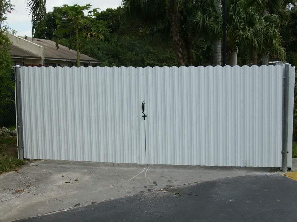 White double swing privacy gate across a driveway